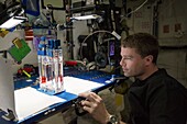 Astronaut conducting experiment on ISS