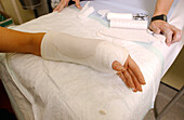 Plaster cast being applied to arm