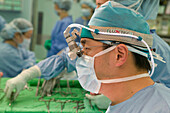 Surgeon wearing binocular glasses
