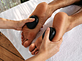 Hot stone foot massage therapy