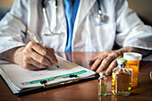 Doctor writing notes on medication