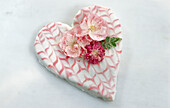 Heart-shaped Valentine's Day cake with sugared rose petals