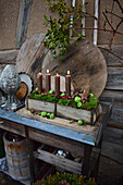Advent arrangement of brown candles in a wooden box