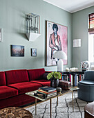 Red velvet sofa in eclectically furnished sitting room