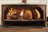 Rindfleisch auf Grillrost über offener Flamme grillen