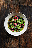 Meatballs, peas, broccoli, pickle red onion and nasturtium leaves