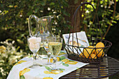 Summer table with sparkling wine and lemons