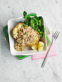 Baked potatoes with a spicy fish curry filling and watercress