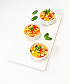 Couscous with summer vegetables served in small bowls