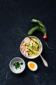 Egg salad garnished with radishes and chives