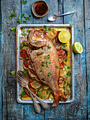Oven baked bream on tomatoes and potatoes