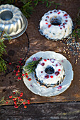 Bird feeder in mini bundt cake moulds with berries and seeds on a rustic base