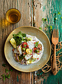 Stockfish salad with cherry tomatoes and pink pepper