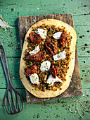 Pizza with stockfish and dried tomatoes