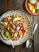 Chickpea salad with boiled eggs and seafood