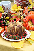 Marble bundt cake decorated with moss and rose hips