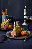Rack of lamb with a herb crust and braised tomatoes