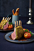 Rack of lamb with a herb crust and braised tomatoes