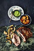 Stuffed veal breast with roasted artichokes and almond basil pesto