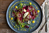 Beetroot salmon with radishes, herbs and lemon dressing