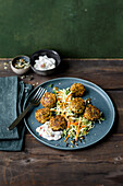 Spicy carrot-and-millet balls with white cabbage salad and a vegan yoghurt dip