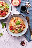 Spaghetti al Pomodoro, topped with spiced yeast flakes and basil, vegan