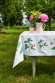 DIY tablecloth with strawberry motif on garden table