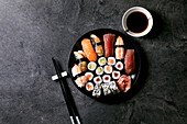 Sushi rolls set with fresh salmon, tuna, eel and prawns on rice. Flat lay, copy space