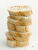Tower of baguette slices on light background