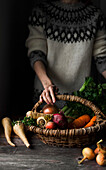A farmer with a basket of fresh autumn vegetables