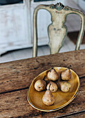 Ceramic plate with pears on rustic wooden table