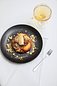Peach cobbler with clotted cream and candied pecan nuts