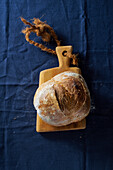 Sourdough white bread loaves on blue linen