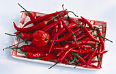 Red chilies on a red and white bowl