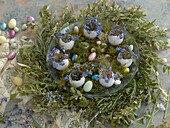 Easter wreath with rosemary, sugar eggs, Easter eggs, and eggshells with forget-me-nots