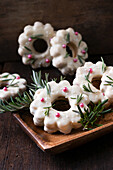 Christmas wreath cookies filled with jam, coated with white rice milk chocolate, vegan