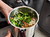 Ingredients for spinach pesto in a metal container