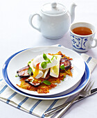 Potato pancakes with bacon, brie and poached egg