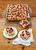 Rhubarb-raspberry cake from the tray with marzipan cut into squares