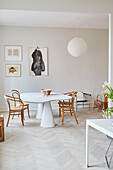 An organically shaped dining table and coffee house chairs in a dining room
