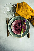 Spring floral table setting decorated with wild purple iris flowers on concrete table