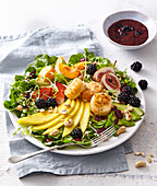 Summer vegetable salad with goat cheesye and blackberry sauce