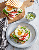 Open sandwich with vegetables and sunny side up egg