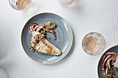 An elegant squid dish served with a light rose wine