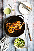 Peruvian inspired roast chicken with a sauce of jalapeno and a cucumber, avocado salad