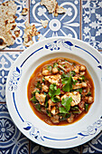 Cauliflower and chickpea stew served with parsley and a flatbread