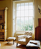 living room with large Georgian window with wooden shutters