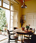 Dining room with view through open French window to patio