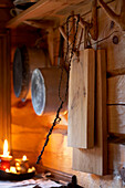 Kitchenware and lit candles in log cabin Svartadalen, Sweden