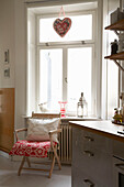 Floral patterned fabric on chair by window of 20th century Stockholm apartment